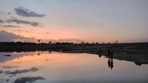 Scenic view of calm sea at sunset