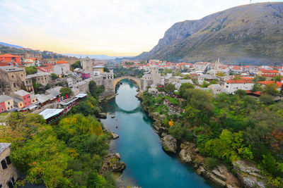 High angle view of townscape by river in town