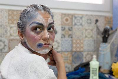 Actress painting and making up to enter the theater stage and play her character. 