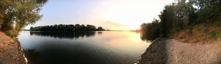 Scenic view of lake against sky at sunset