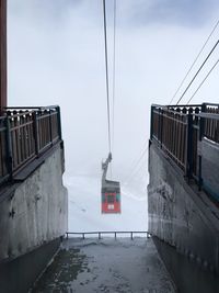 Overhead cable car against sky during winter