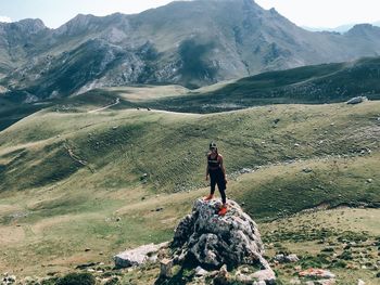 Full length of women standing on rock against mountains