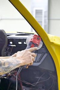 Cropped image of man repairing car