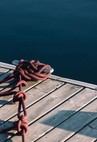 Rope tied in knots on pier at marina.