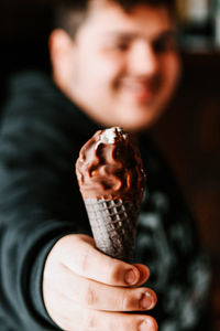 Close-up of hand holding ice cream