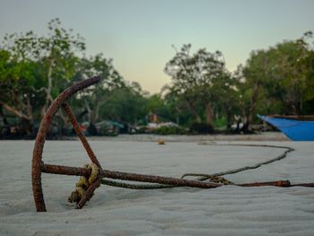 Close-up of rope on riverbank against sky