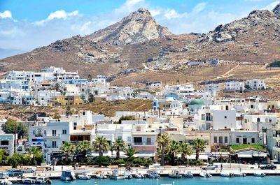 Houses in town against cloudy sky