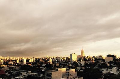 High angle view of buildings against cloudy sky