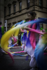 Blurred motion of woman walking in city