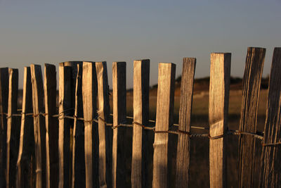 Wooden fence against clear sky
