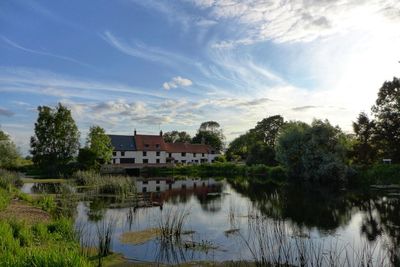 Lake and buildings against sky