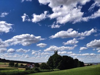 Scenic view of field against cloudy sky