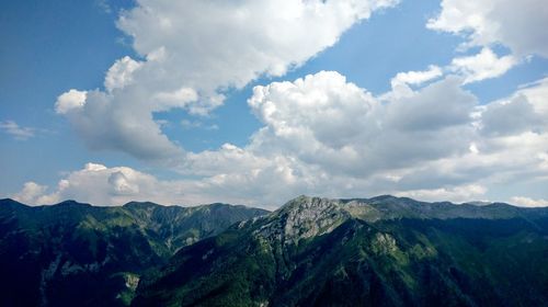 Scenic view of rocky mountains against cloudy sky