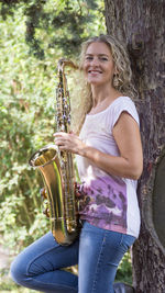 Smiling young woman playing outdoors