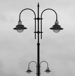 Low angle view of street light against sky