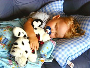 High angle view of woman lying down on bed