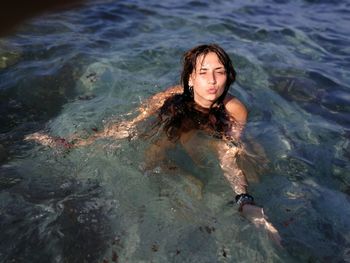 High angle view of woman swimming in sea