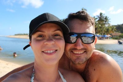 Portrait of smiling mid adult couple at beach