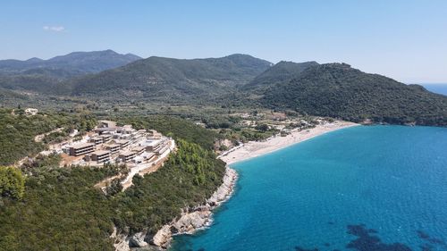 High angle view of sea and mountains against sky