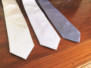 High angle view of neckties on wooden table