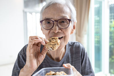 Portrait of senior woman eating food