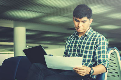 Young man sitting on seat