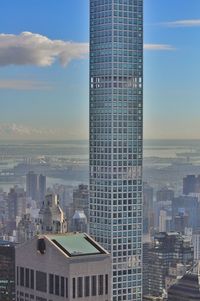 Aerial view of cityscape against blue sky