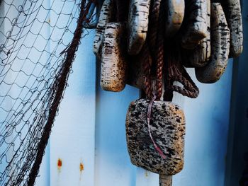 Close-up of fishing nets hanging against wall