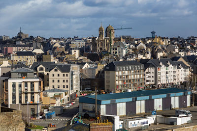 High angle view of houses in town against sky