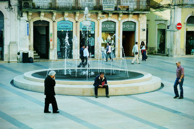 People walking on street in city