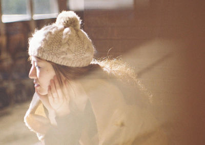 Close-up portrait of woman wearing hat