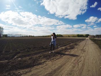 Full length of man standing on field against sky