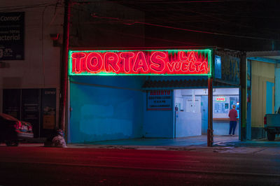 View of illuminated red store