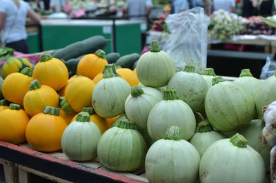 Pile of fresh young zucchinis on a green market stall