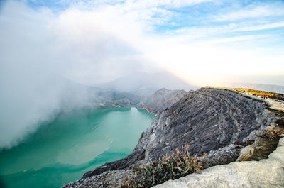 Scenic view of sea and mountains against sky