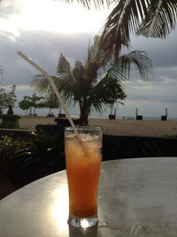 Close-up of drink on table at beach