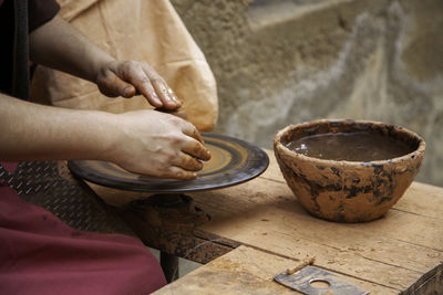 Midsection of man preparing food on table