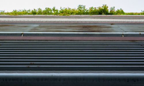 Close-up of pipes against sky during winter