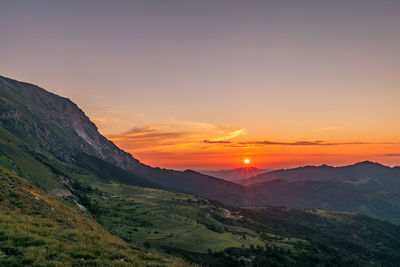 Scenic view of mountains against sky during sunset