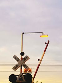 Low angle view of road sign against sky