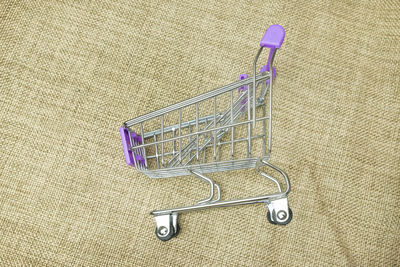 Directly above shot of empty shopping cart on burlap