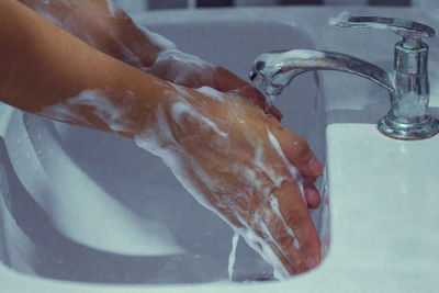 Close-up of human hand in bathroom