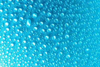 Water drops on blue glass