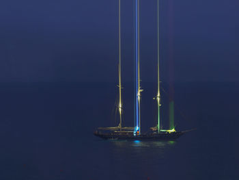 Sailboat in sea against blue sky