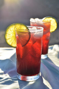 Cold iced tea made from hibiscus flower petal tea in hot desert setting
