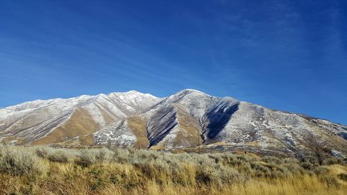 Low angle view of mountain against clear blue sky