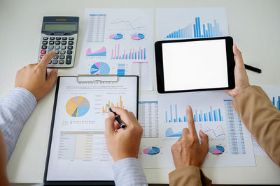 Cropped image of colleagues working at desk in office