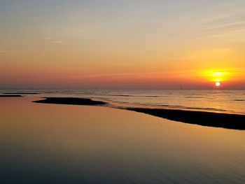 Scenic view of beach against sky during sunset