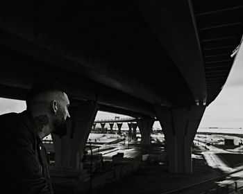 Man standing on bridge