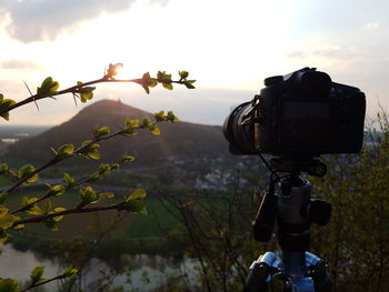 Close-up of camera against sky